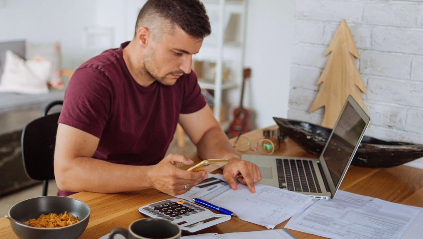 a young man researching the cost to become a home inspector