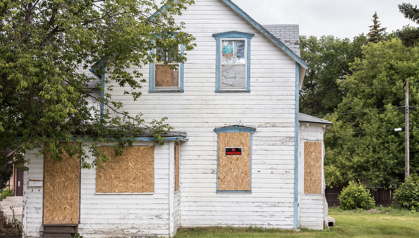 Can a home inspector condemn a house? A photo of a crumbling, boarded up old home that is unsafe to live in.